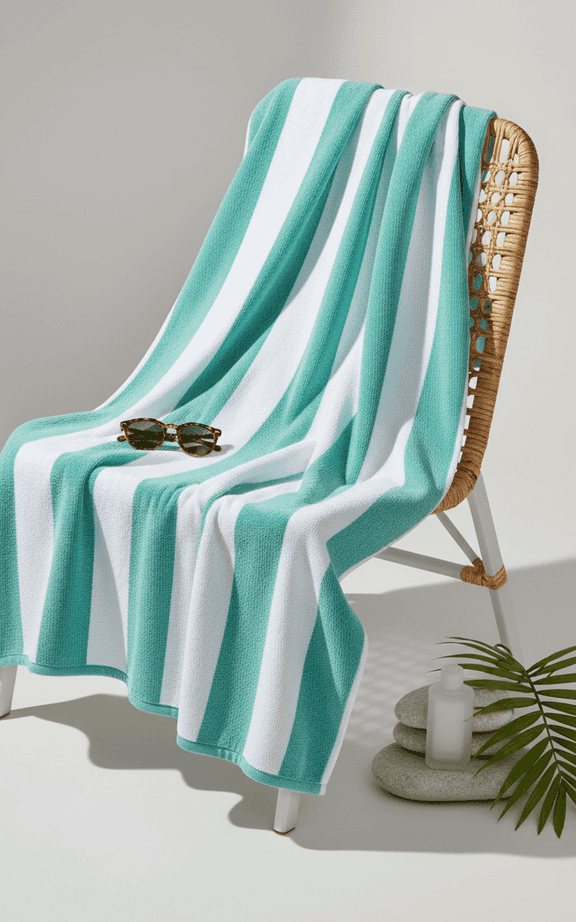 Wide teal and white striped resort towel with vertical stripes and plush construction
