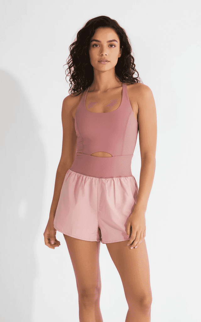 Dusty rose romper with contrast shorts and waist cutout for sporty casual wear